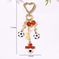 Side view of the sports ball keychain showing its round shape and texture