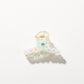 Bright multi color hair clip with clasp partially open