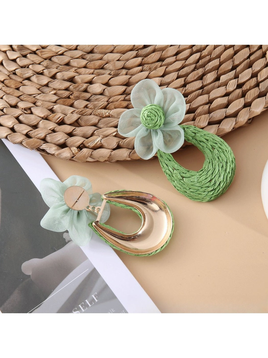 Sweet Raffia Flower Shaped Stud Earrings on a minimalist white jewelry stand