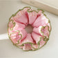 Pink lace scrunchie displayed flat showing intricate lace details and elastic band
