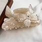 Detailed shot of butterfly motifs on Beau colorful hair claw clip