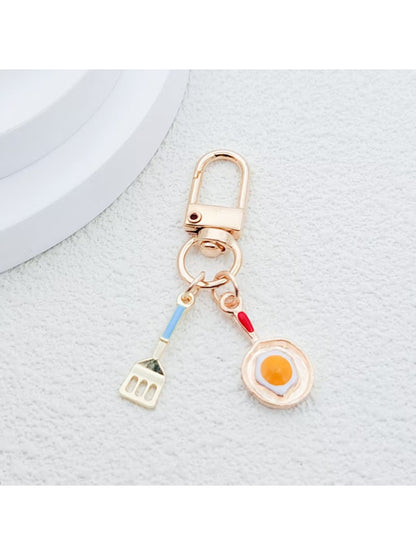 Spatula keychain held in hand highlighting texture and design