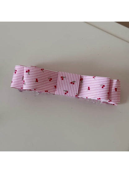 Top view of Beau pink floral pattern hair clip with metal clip visible