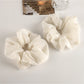 Gifty fashion scrunchie styled on a wrist with casual outfit