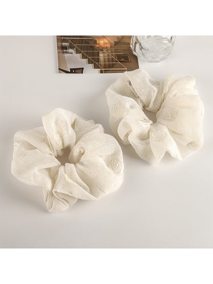 Gifty fashion scrunchie styled on a wrist with casual outfit