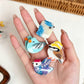 Mini bird character hair claw clips held in hand