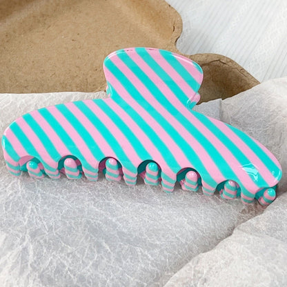 Pink and blue striped hair claw clip, front view