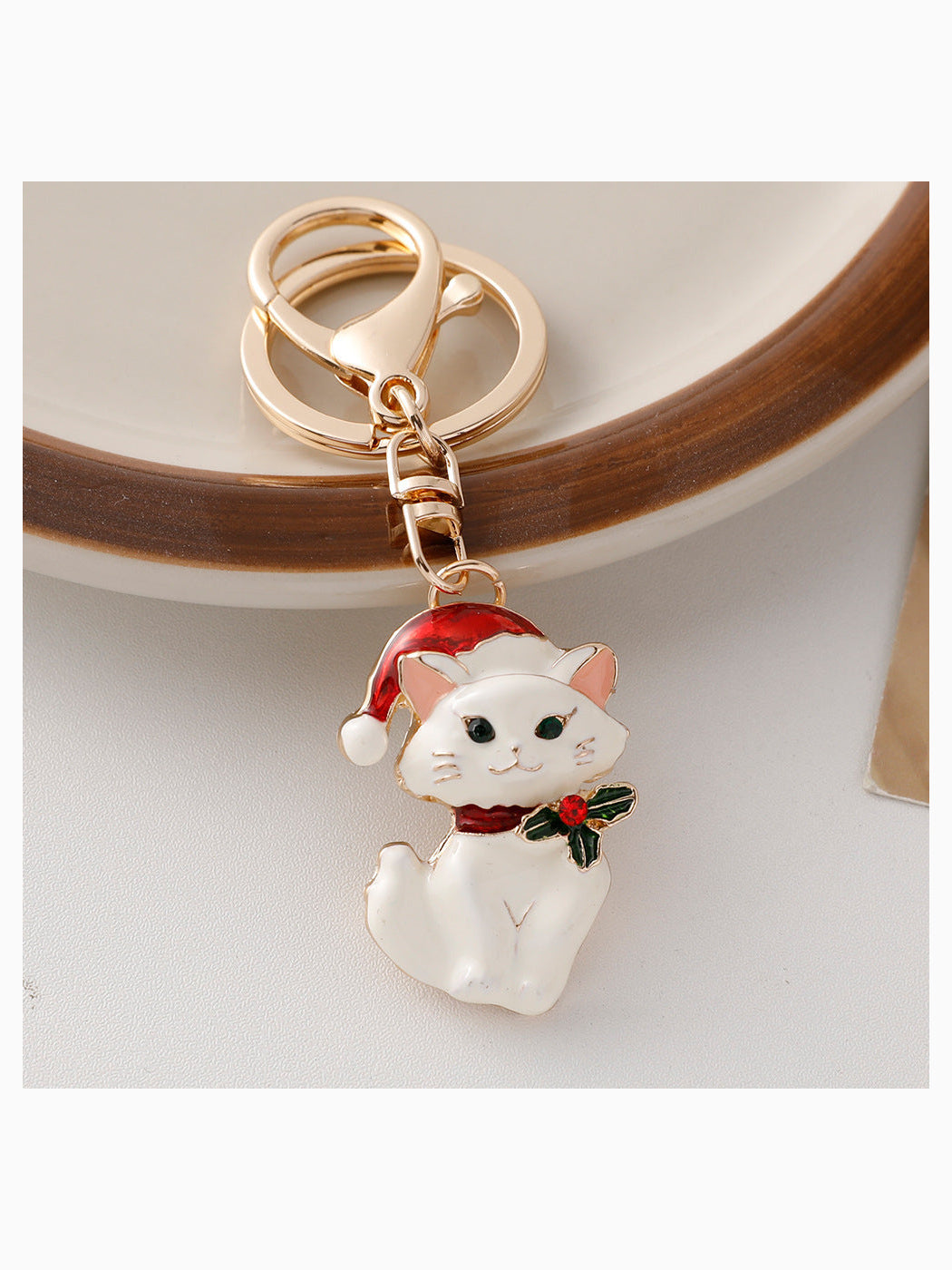 White Christmas cat keychain with Santa hat and holly