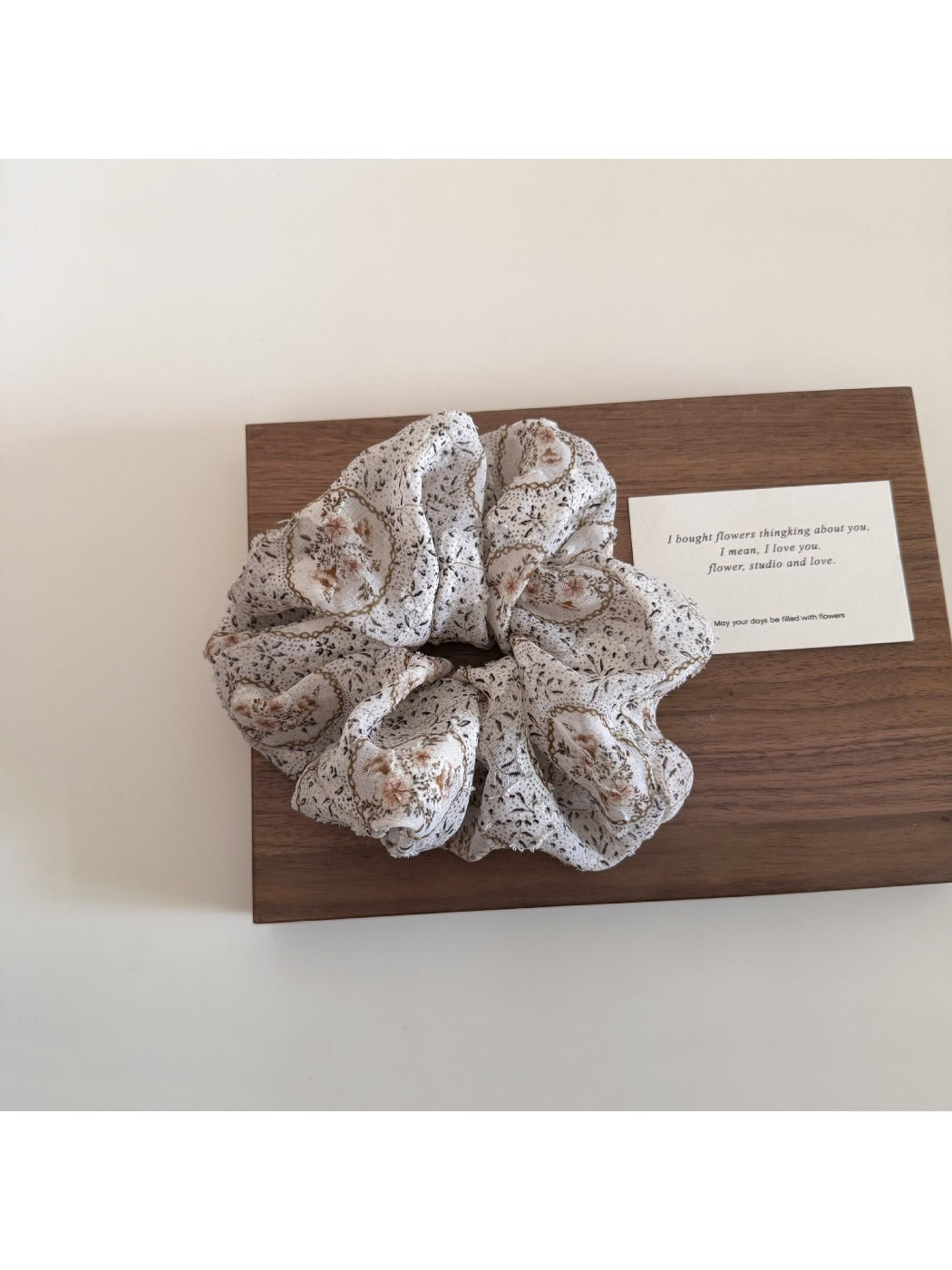 Side view of Gifty scrunchie showing elastic band inside floral fabric