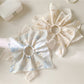 Close-up of Gifty novel unique creative scrunchie in pastel colors on white background