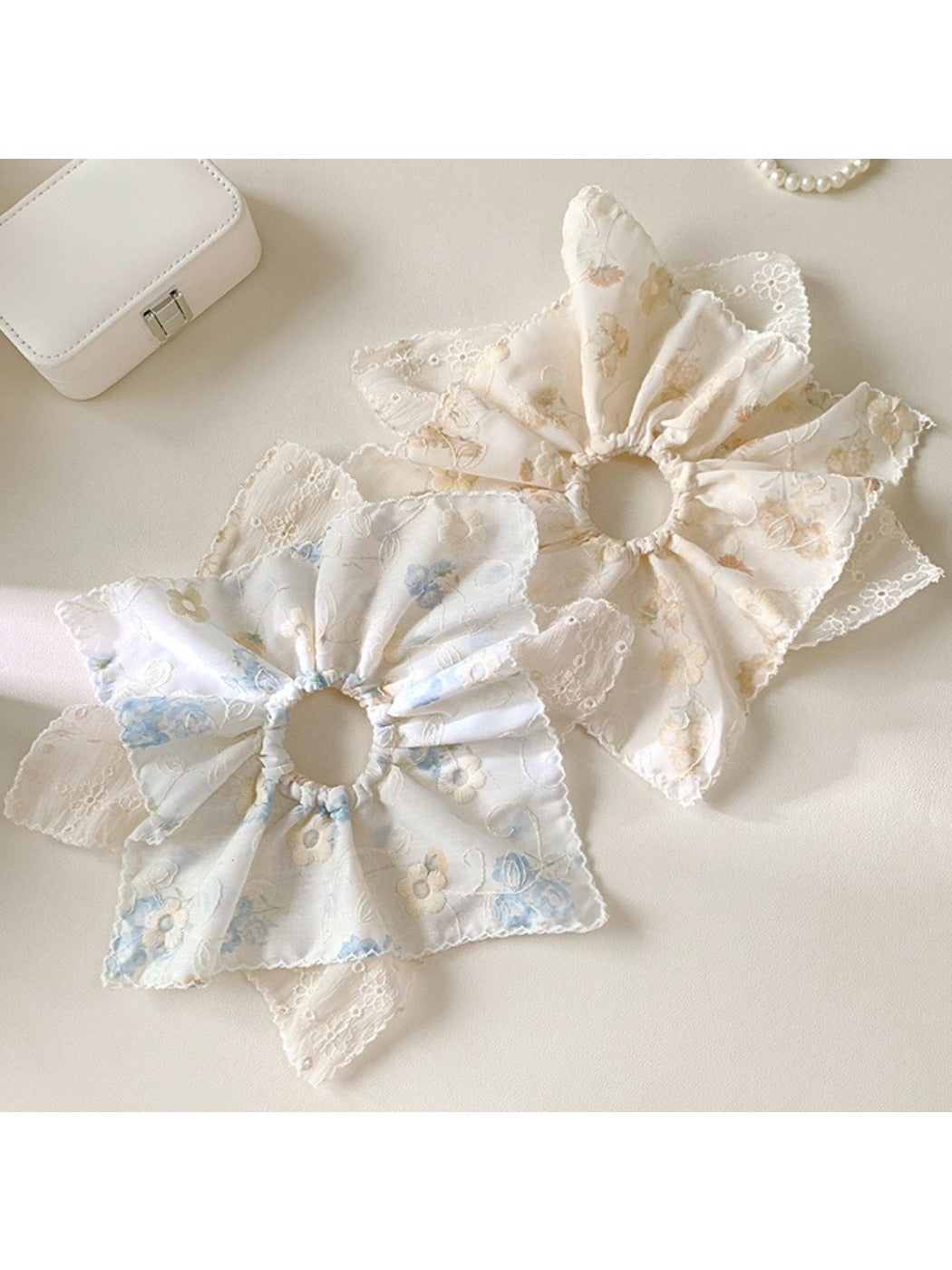 Close-up of Gifty novel unique creative scrunchie in pastel colors on white background