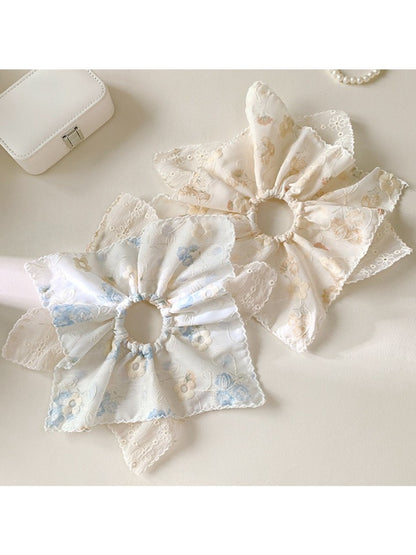 Close-up of Gifty novel unique creative scrunchie in pastel colors on white background