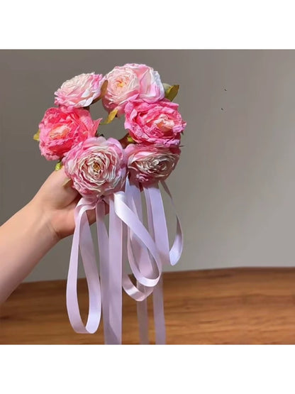 Beau Sweet Lifelike Flower Ribbon Hair Clip attached to brown hair