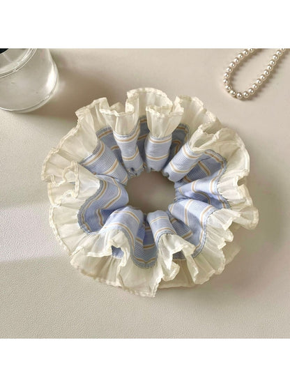Close-up of Gifty cloudy scrunchie showing soft fabric texture and gentle folds