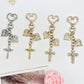 Vintage cross pendant keychain with intricate metalwork on a keyring