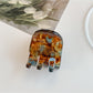 Beau hair clip positioned next to matching accessories for styling inspiration