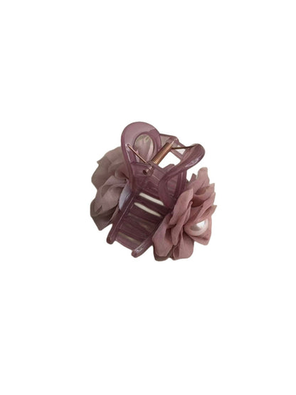 Close-up of soft purple hair clip showing detailed fabric texture and clasp mechanism