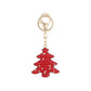 Red Christmas tree keychain on white background