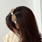 Flat lay of Gifty vintage chic wide edge headband highlighting fabric and shape
