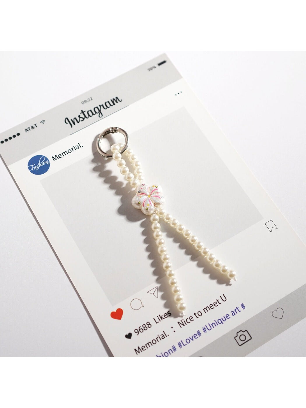 Keypus keychain featuring a handcrafted bow made of small pink and white beads