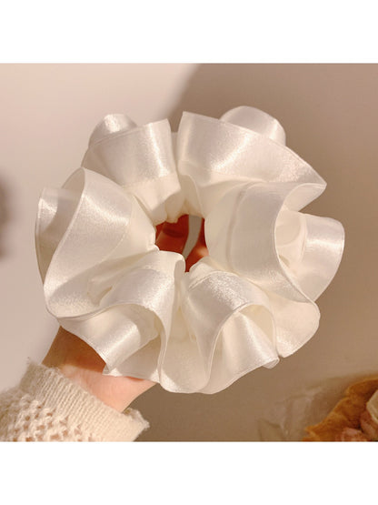 Side view of Gifty satin ruffle scrunchie highlighting smooth fabric and gathered design