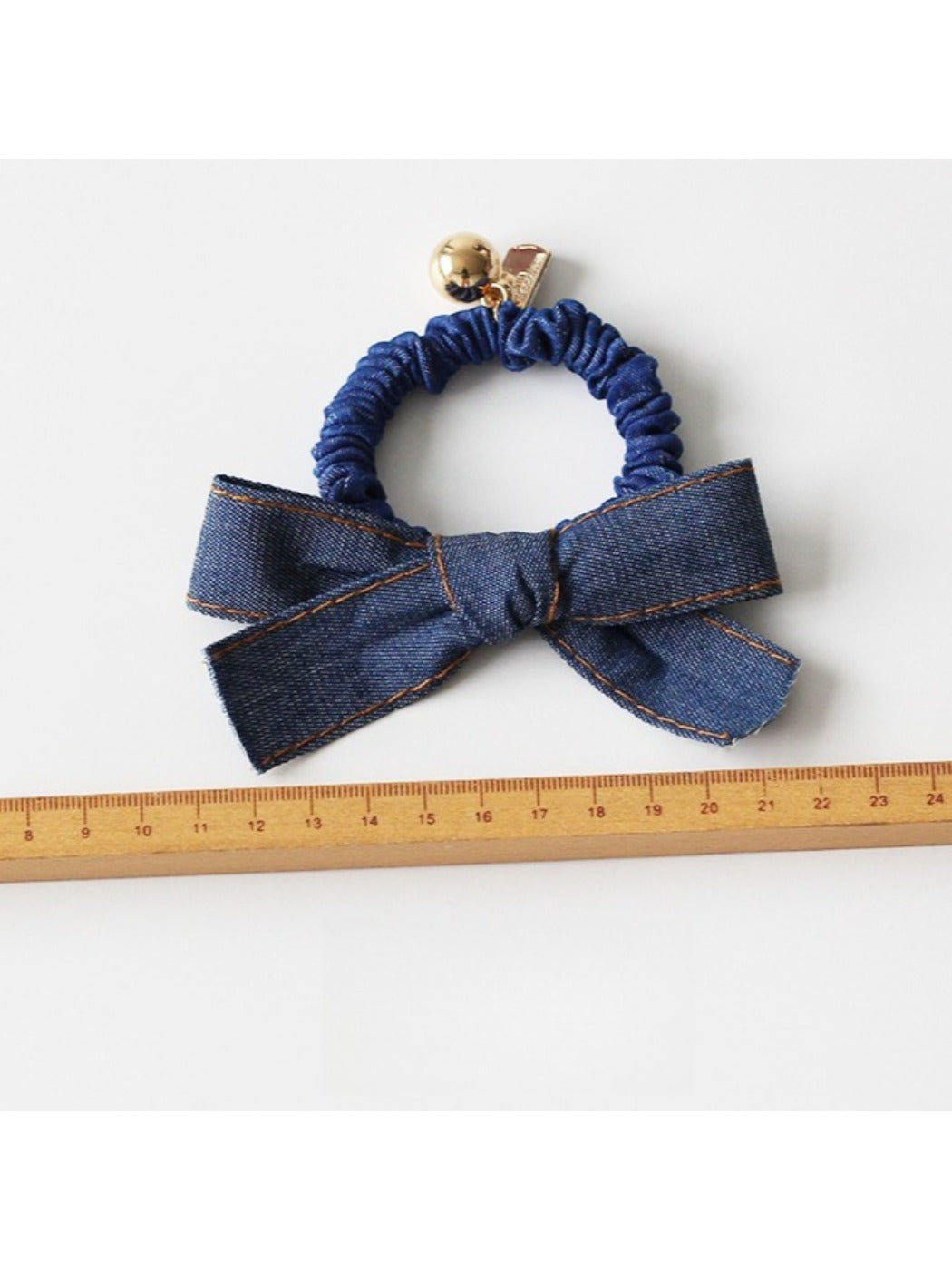 Vintage bow hair tie displayed flat on white background showing elastic band