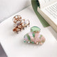 Beau vintage small crescent shaped claw clip held in hand to show size and scale