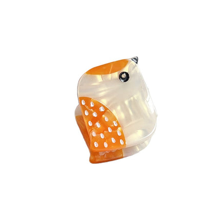 Yellow freckled bird hair claw clip on white background