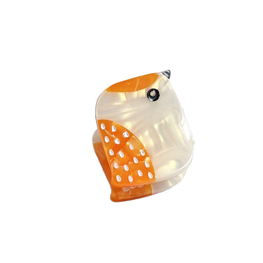 Yellow freckled bird hair claw clip on white background
