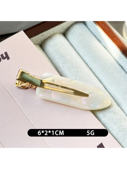 Beau acetate invisible hair clip clipped into blonde hair from side angle