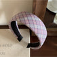 Flat lay of the wide plaid headband alongside matching accessories