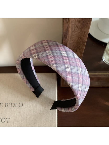 Flat lay of the wide plaid headband alongside matching accessories