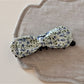 Beau bow hair clip worn in blonde hair, displaying its size and artistic design