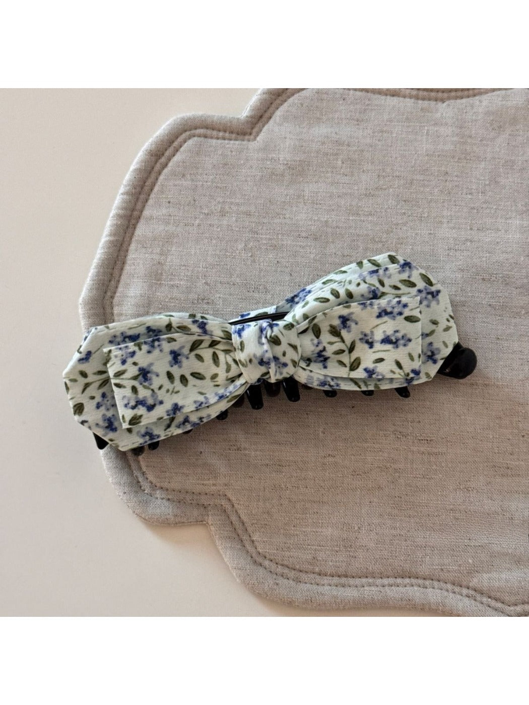 Beau bow hair clip worn in blonde hair, displaying its size and artistic design