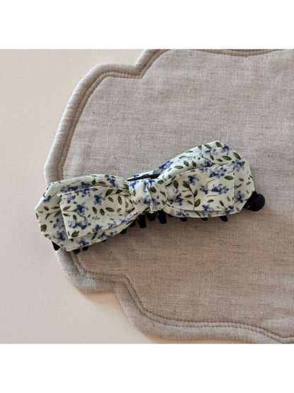 Beau bow hair clip worn in blonde hair, displaying its size and artistic design