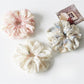 Gifty ruched scrunchie showing gathered fabric texture and vibrant print