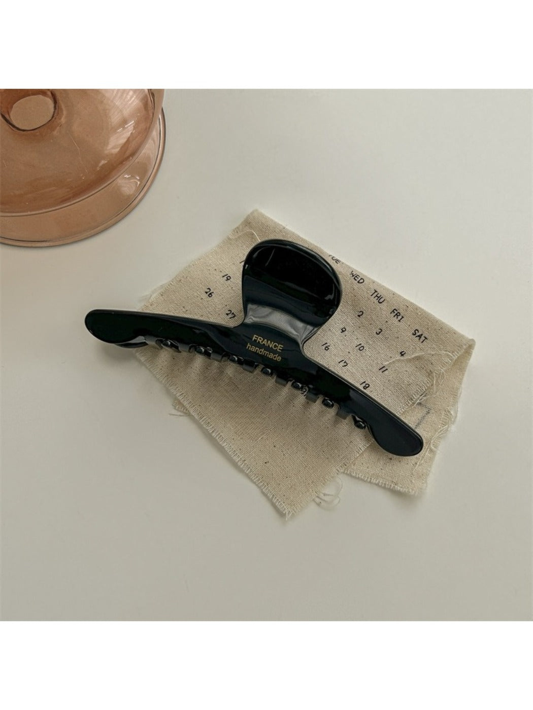 Beau chic acetate claw clip shown from the bottom to display hinge details