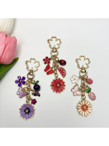 Close-up of delicate daisy charm on a gold keychain with a lobster clasp