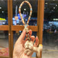 Keypus squirrel charm keychain hanging from a backpack zipper pull