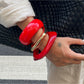 Close-up of Lovra irregular bangle bracelet showing smooth metal finish