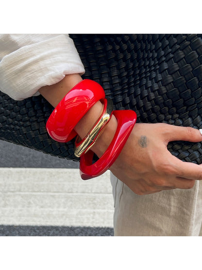 Close-up of Lovra irregular bangle bracelet showing smooth metal finish