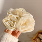 Beau hair claw clip with elegant rose decoration in soft pink and gold accents
