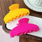 Side view of Beau Candy Polka Dot acetate claw clip highlighting curved design