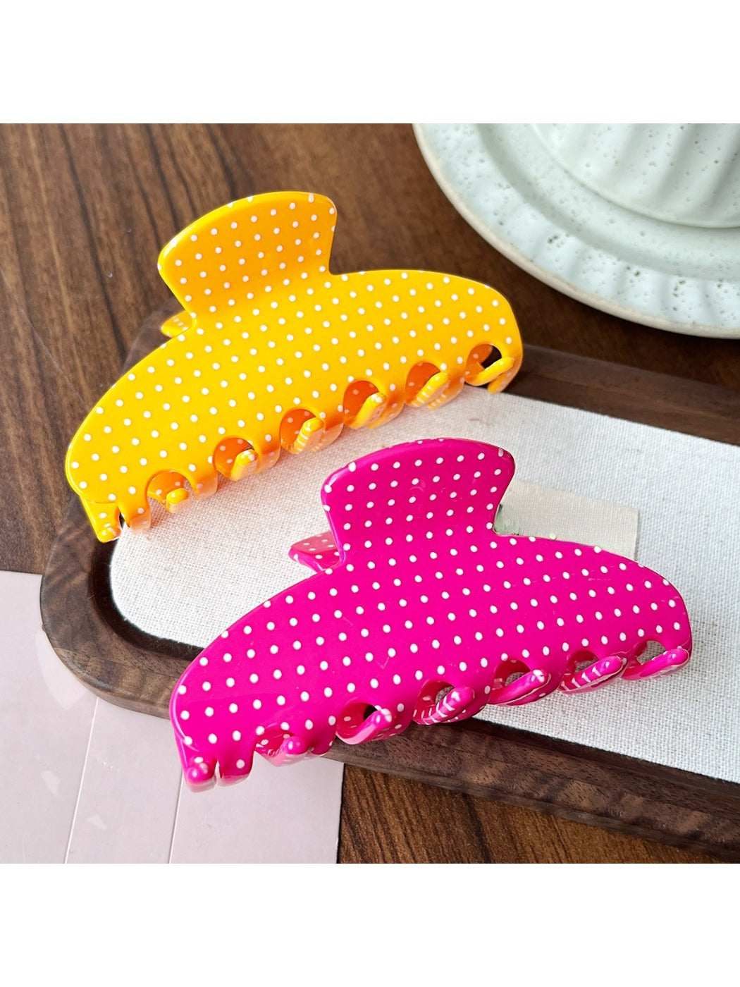 Side view of Beau Candy Polka Dot acetate claw clip highlighting curved design