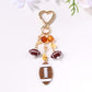 Sports ball shaped pendant keychain displayed on a white background