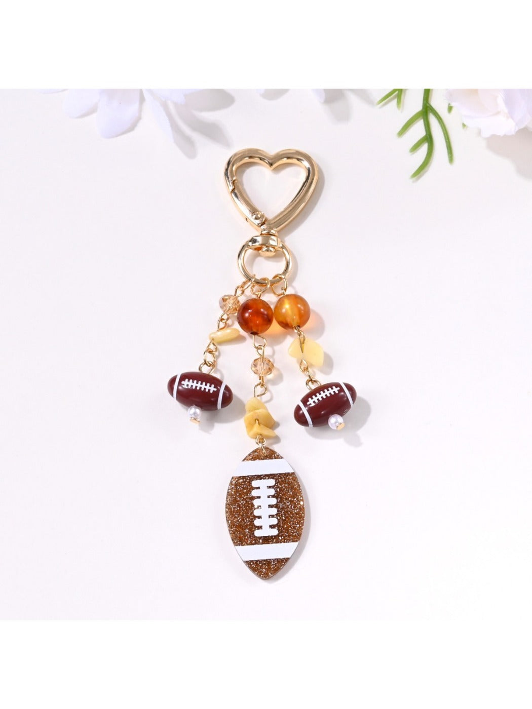 Sports ball shaped pendant keychain displayed on a white background