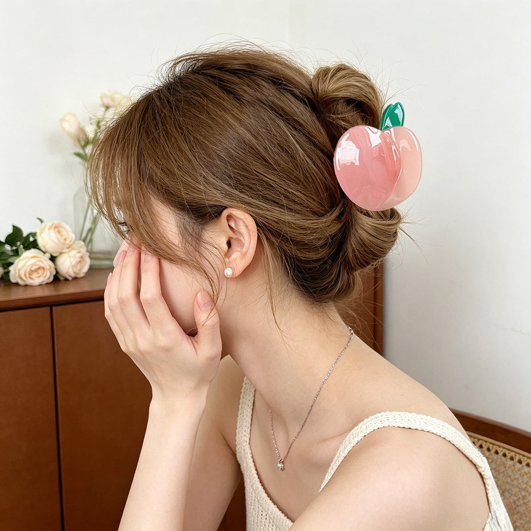 Pink peach hair claw clip in an updo