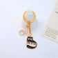 Top view of cartoon cat piano keychain showing piano keys and cat ears