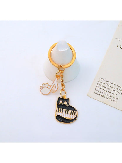 Top view of cartoon cat piano keychain showing piano keys and cat ears