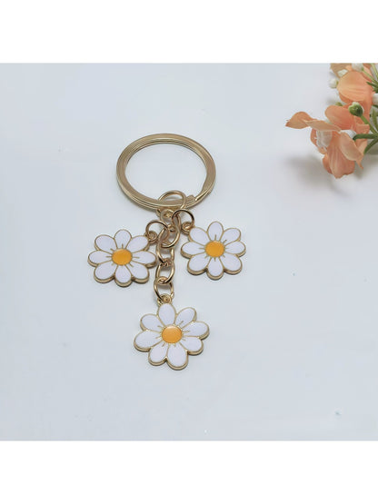 Close-up of peach blossom keychain showing detailed petal texture and gold ring